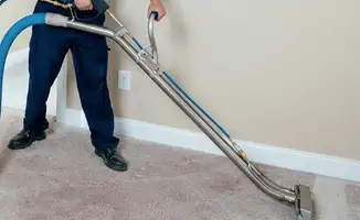 Professional operating a liquid removal machine on a carpeted floor in Yonkers, NY